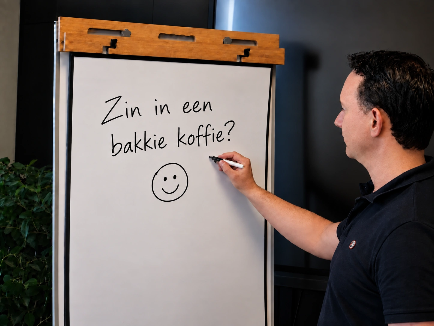 Pascal schrijft 'Zin in een bakkie koffie?' op een flip-over